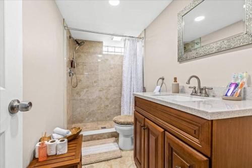 a bathroom with a sink and a shower at Newly Renovated 4 Bedroom 2 Bath Downtown Dearborn in Dearborn
