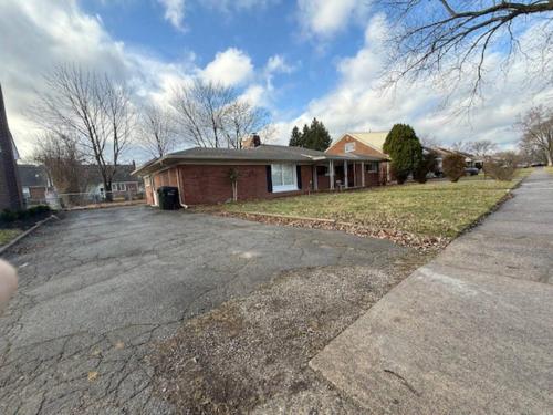 a house with a driveway in front of it at Newly Renovated Gem Fenced Backyard 2 Full Baths in Allen Park