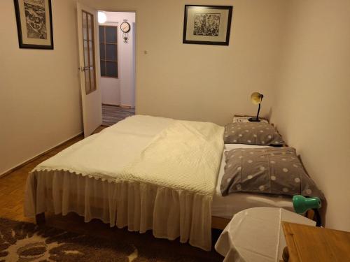 a bedroom with a bed and a table at Lokum u Krzysztofa in Krosno