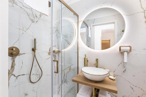 a bathroom with a sink and a shower at La Casa delle Dee - Self Check-in in Bologna