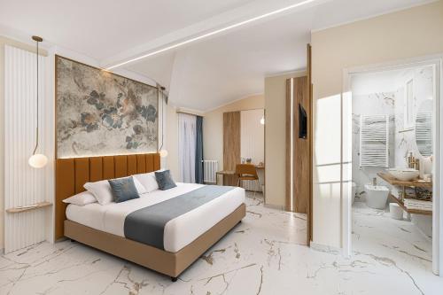 a bedroom with a bed and a bathroom at La Casa delle Dee - Self Check-in in Bologna