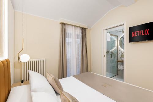 a hotel room with a bed and a mirror at La Casa delle Dee - Self Check-in in Bologna