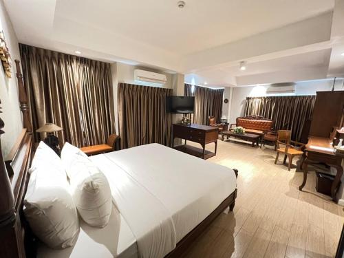 Ένα ή περισσότερα κρεβάτια σε δωμάτιο στο Kokhaburi Hotel