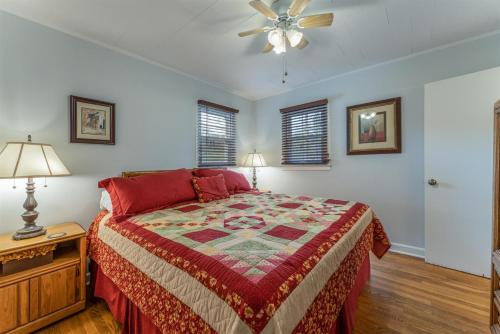 a bedroom with a bed and a ceiling fan at Bike Path Getaway in Town in Brevard