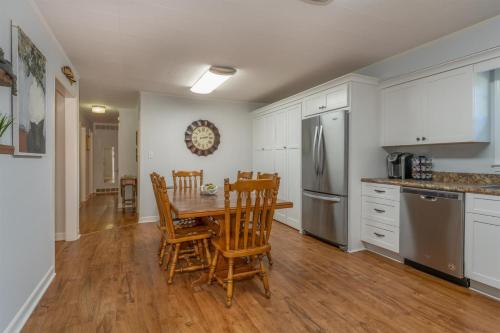 a kitchen with a table and chairs and a refrigerator at Bike Path Getaway in Town in Brevard