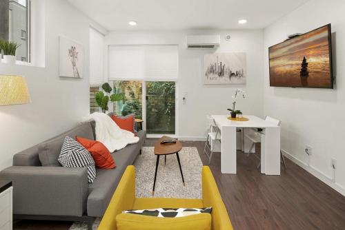 a living room with a gray couch and a desk at Perch - Centro house F in Seattle