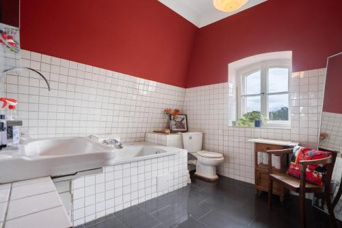 a bathroom with a tub and a toilet and a sink at Wohnen Im Alten Rittergut - Calau in Calau