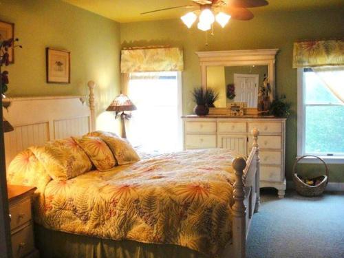 a bedroom with a bed and a dresser and a window at Y1485- Sunnybank in Corolla