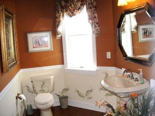 a bathroom with a toilet and a sink and a window at Y1485- Sunnybank in Corolla