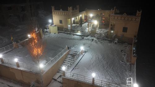 an aerial view of a building in the snow at night at Auberge & Restaurant Agoudal in Agoudal