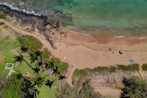 an overhead view of a beach with palm trees and the ocean at Kamaole Beach Club B107 in Kihei