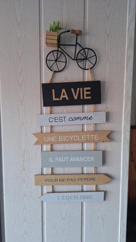 a shelf of books with a bike on top at Gîte l'hippocampe in Jarjayes