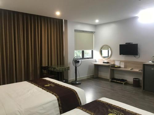 Ένα ή περισσότερα κρεβάτια σε δωμάτιο στο CIAO Hotel