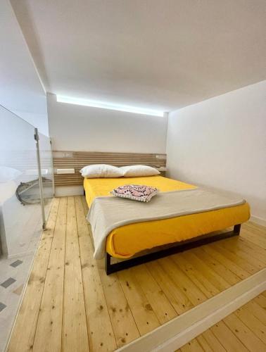 a bed in a room with a wooden floor at Casa Mondello Sea Life in Palermo