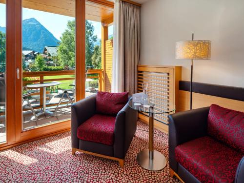 a living room with two chairs and a table at aja Fürstenhaus am Achensee in Pertisau