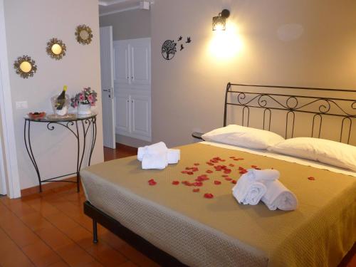 a bedroom with a bed with flowers on it at La Villetta nel Parco in La Giustiniana