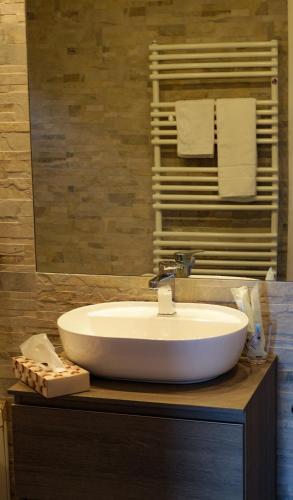 a bathroom with a white sink and a mirror at La Villetta nel Parco in La Giustiniana