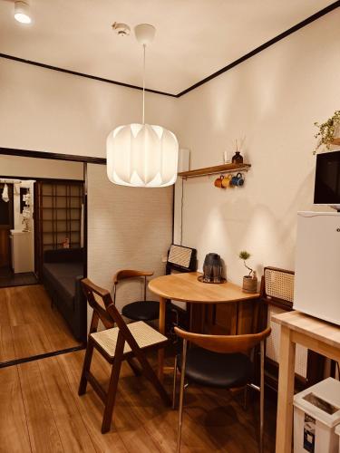 a kitchen and dining room with a table and chairs at Leisureyado USJ 5 min train 悦宿西九条 in Osaka