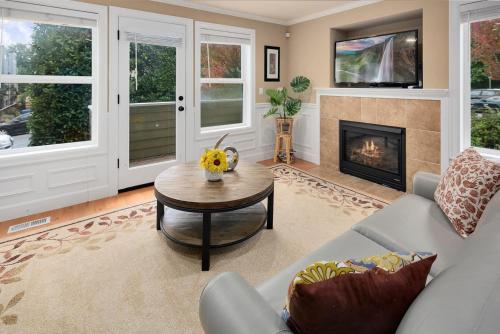 a living room with a couch and a fireplace at Perch - Cozy Ensuites in Seattle