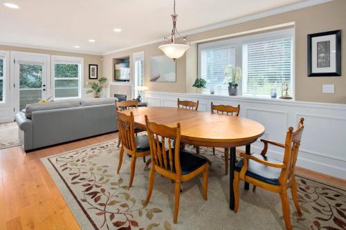 a dining room and living room with a table and chairs at Perch - Cozy Ensuites in Seattle