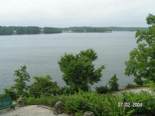 a view of a large body of water with a bench at Lodge of Four Seasons Golf Resort, Marina & Spa in Lake Ozark