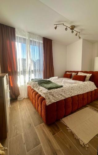 a bedroom with a large bed with a large ottoman at Casa Familia Jahorina in Jahorina