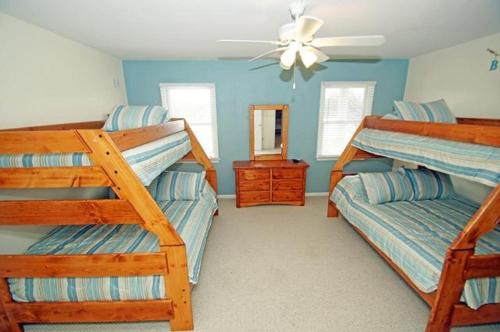 a bedroom with two bunk beds and a mirror at KH4508- Surf Par-Tee in Kitty Hawk