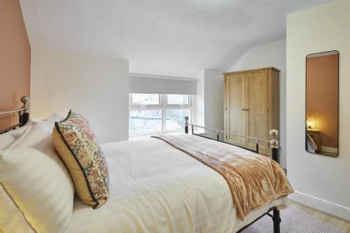 a bedroom with a large bed and a window at Host & Stay - Cedar Cottage in Belford