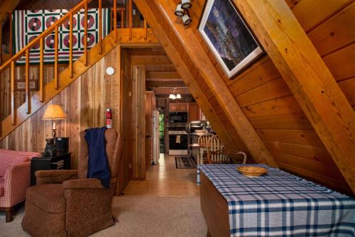 a living room with a staircase and a table at Chestnut Ridge in Connestee in Rosman