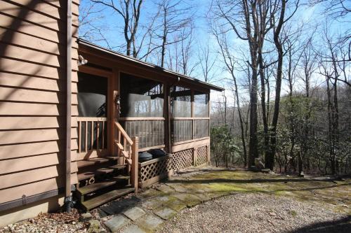 a screened in porch of a house with trees at Chestnut Ridge in Connestee in Rosman