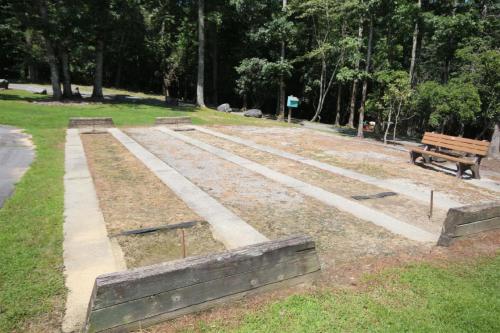a park with a bench and some dirt and grass at Chestnut Ridge in Connestee in Rosman