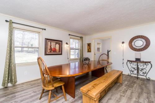 a dining room with a wooden table and a bench at Downtown Family Retreat - 5 Beds & 3.5 Baths in Dahlonega