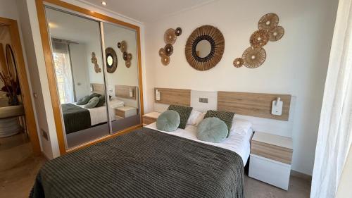 a bedroom with a bed and a large mirror at F10 - Vila D Orpesa X, World Lujo - ServHouse in El Borseral