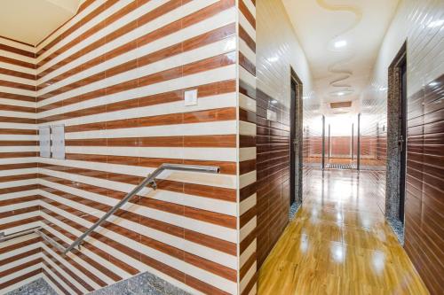 a hallway with wooden walls and a staircase at FabHotel Maa Gayatri Sadan - Nr Pram Mandir Shree Banke Bihari Temple in Vrindāvan