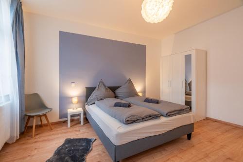 a bedroom with a bed with a large mirror at Traumhaftes Apartment mitten in Halle an der Saale No2 in Halle an der Saale