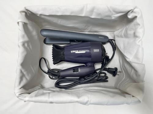 a hair dryer and a blow dryer with a cord at Busan Vacance Stay, cozy house in Busan