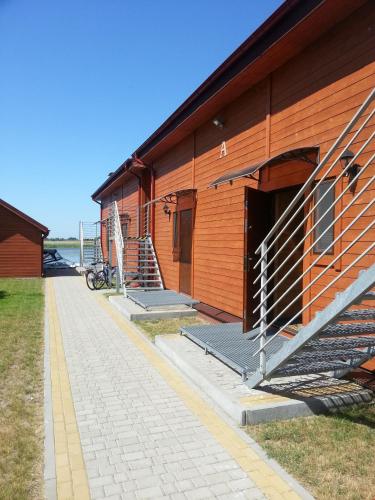 a building with stairs on the side of it at Karczma Rybna Rybaczówka Marina B&B in Świnoujście