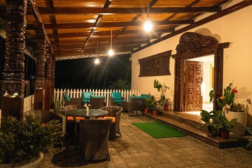 an outdoor patio with a table and chairs and a table and chairs at Cilantro Unwind Delisso Abode ,Pelling in Pemayangtse