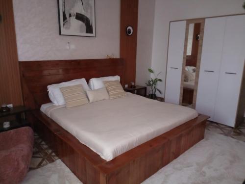 a bedroom with a large bed with white sheets at Furnished Downtown 2 Bedrooms in Brazzaville