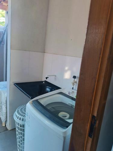 a small bathroom with a toilet with a sink at Ambiente Familiar e Próx a Tudo! in Prado
