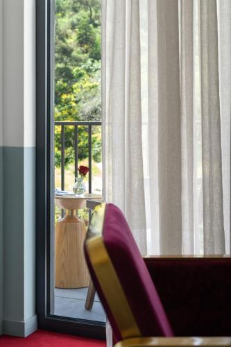 a chair sitting in front of a window at Tbilisi View Hotel in Tbilisi City
