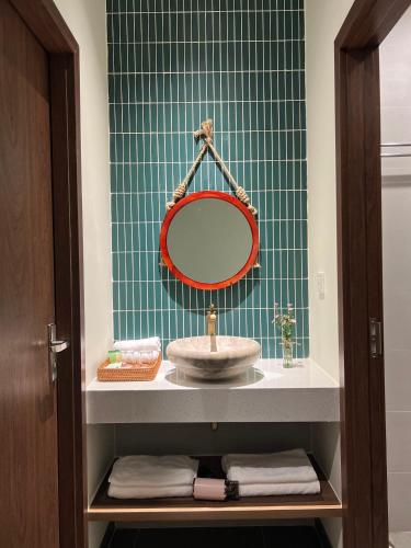 a bathroom with a sink and a mirror at De V’Charm Hotel in Ðông Tác (1)