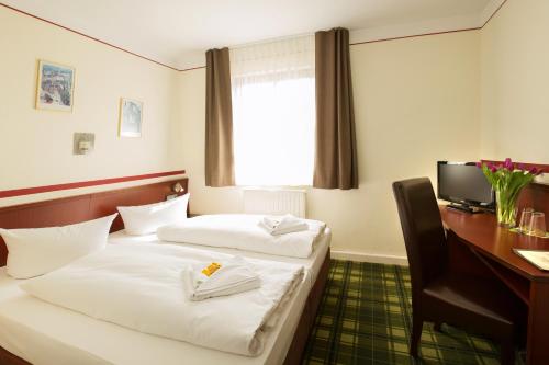 Ένα ή περισσότερα κρεβάτια σε δωμάτιο στο Hotel Weisse Elster