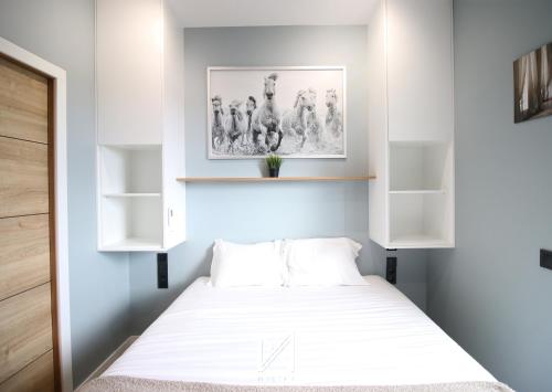 a small bedroom with a bed and shelves at Mystay - Riverview House in Porto