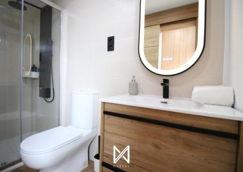 a bathroom with a toilet and a sink and a mirror at Mystay - Riverview House in Porto