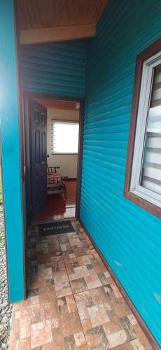 a blue house with a door and a window at Cabañas Alto las Torres in Los Ángeles