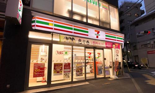 a store with signs in the windows of a building at The Villa Ebisu BLUE惠比寿駅徒步8分 静かな住宅地 in Tokyo