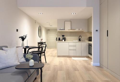 a living room and kitchen with a couch and a table at Signature Studio JLT in Dubai