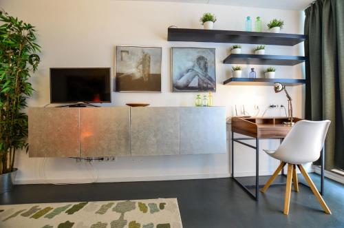 a living room with a desk and a television at K314 in Bonn