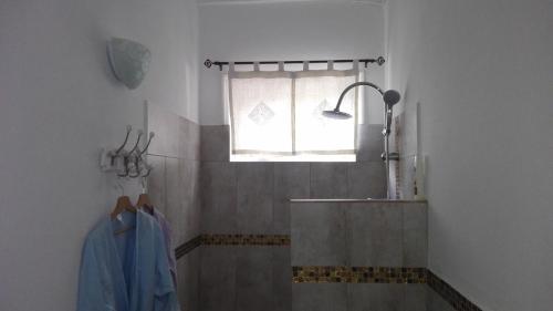 a bathroom with a sink and a window at Donkey on the Beach in Cobbs Cross